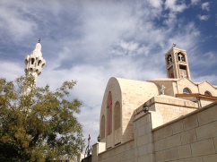 Minaret of the King Abdullah I Mosque and the Coptic Orthodox Church in the Abdali neighborhood of Amman.