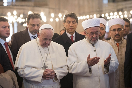 Pope Francis prays with Istanbul's grand mufti Rahmi Yaran during a visit to the Sultan Ahmed Mosque, also known as the Blue Mosque, in Istanbul Nov. 29. (CNS photo/L'Osservatore Romano via Reuters) See POPE-ISTANBUL Nov. 29, 2014.